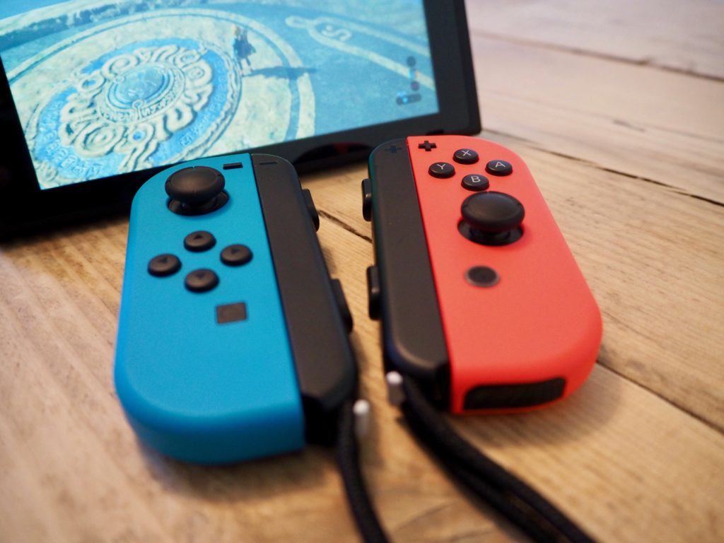 Nintendo Switch with detached Joy-Con controllers and wrist straps